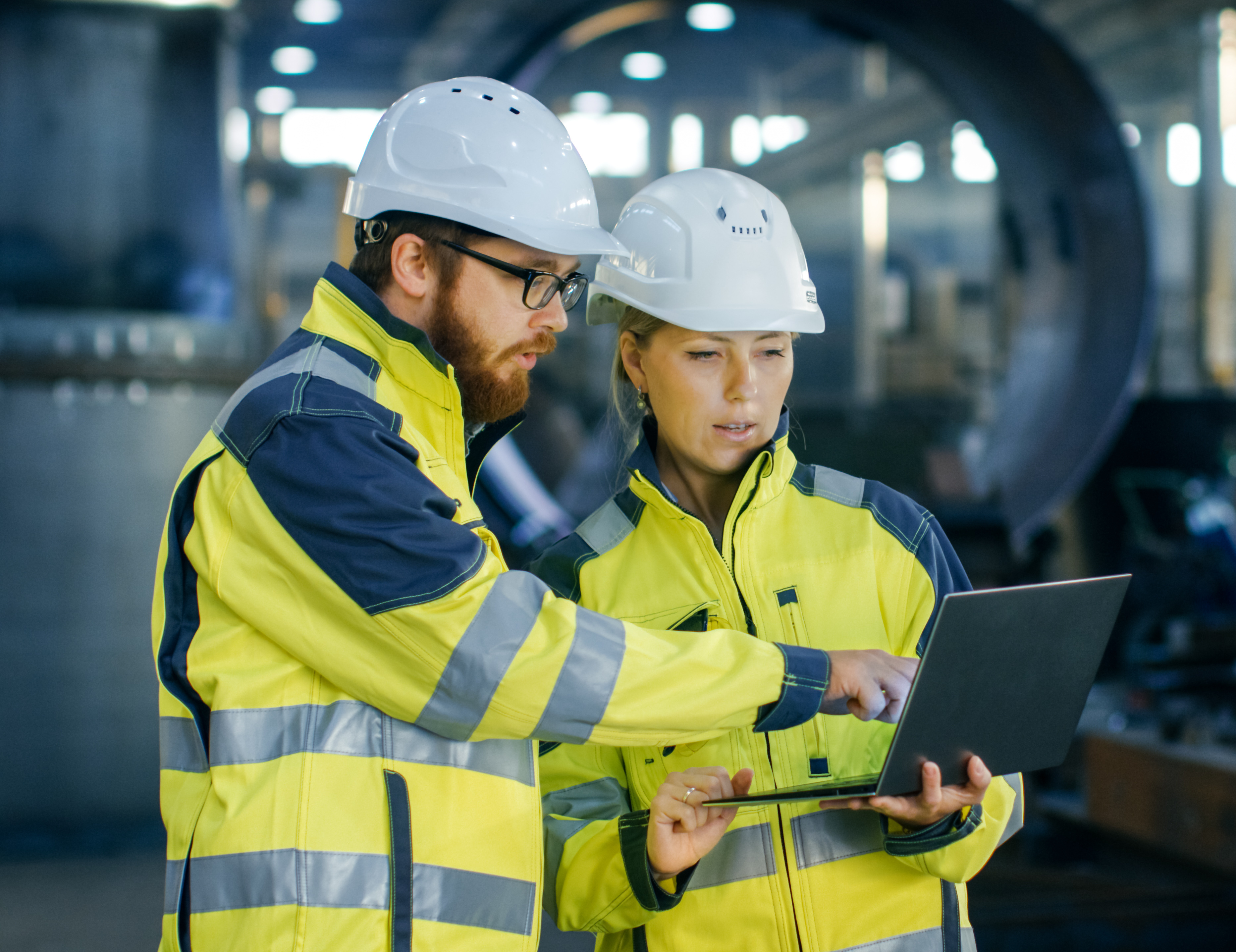 Industrial workers in safety gear collaborating on workplace health initiatives